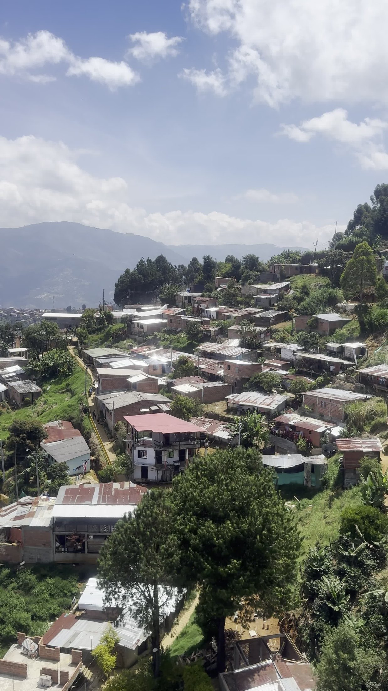 Green hillside homes on the cable-car route toward Parque Arví in Medellín