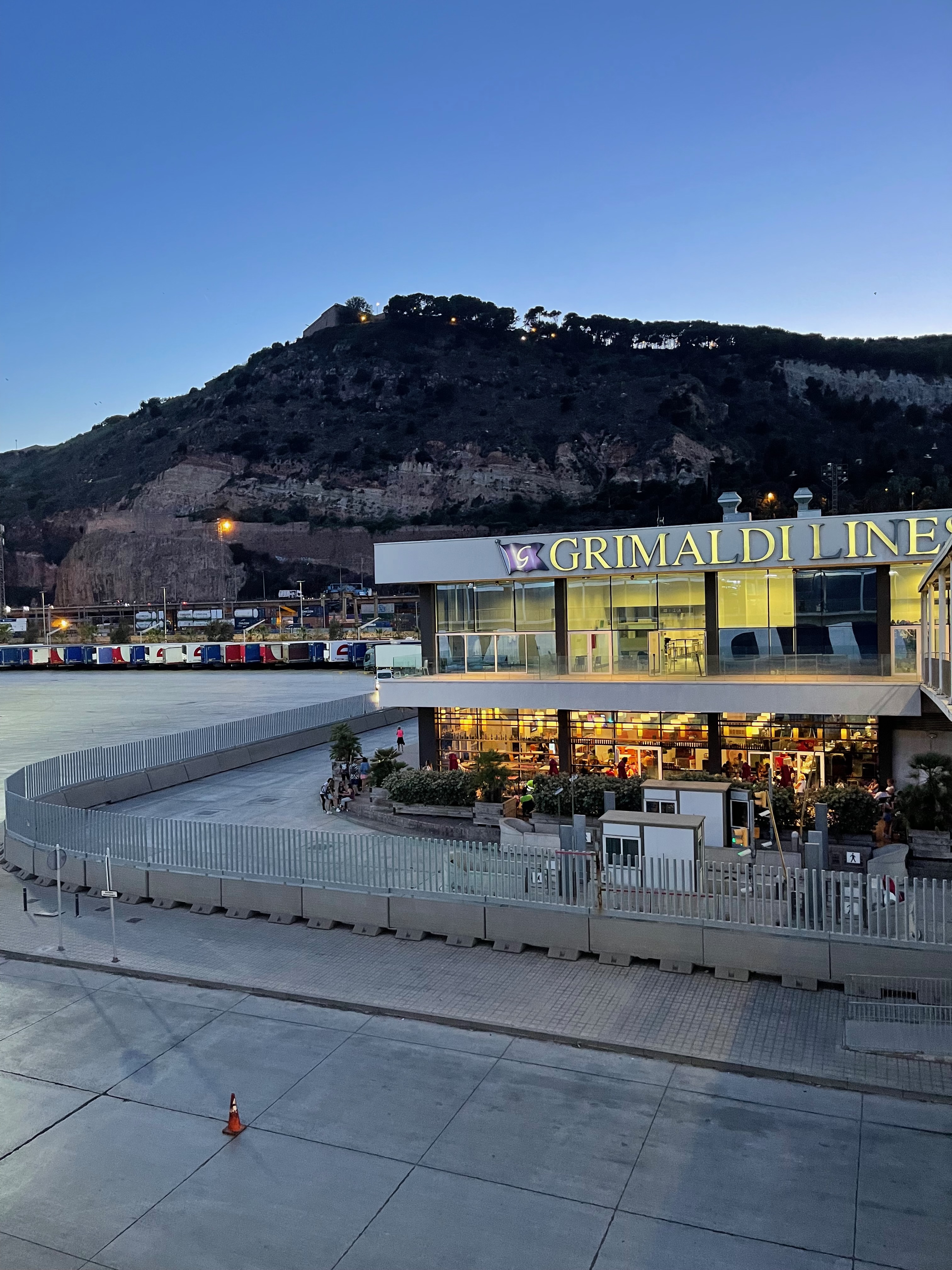 Grimaldi Lines terminal building in Barcelona at dusk.