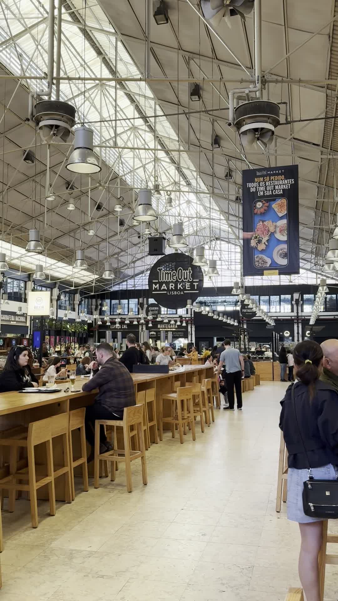 The central hall and long communal tables inside Time Out Market Lisboa.