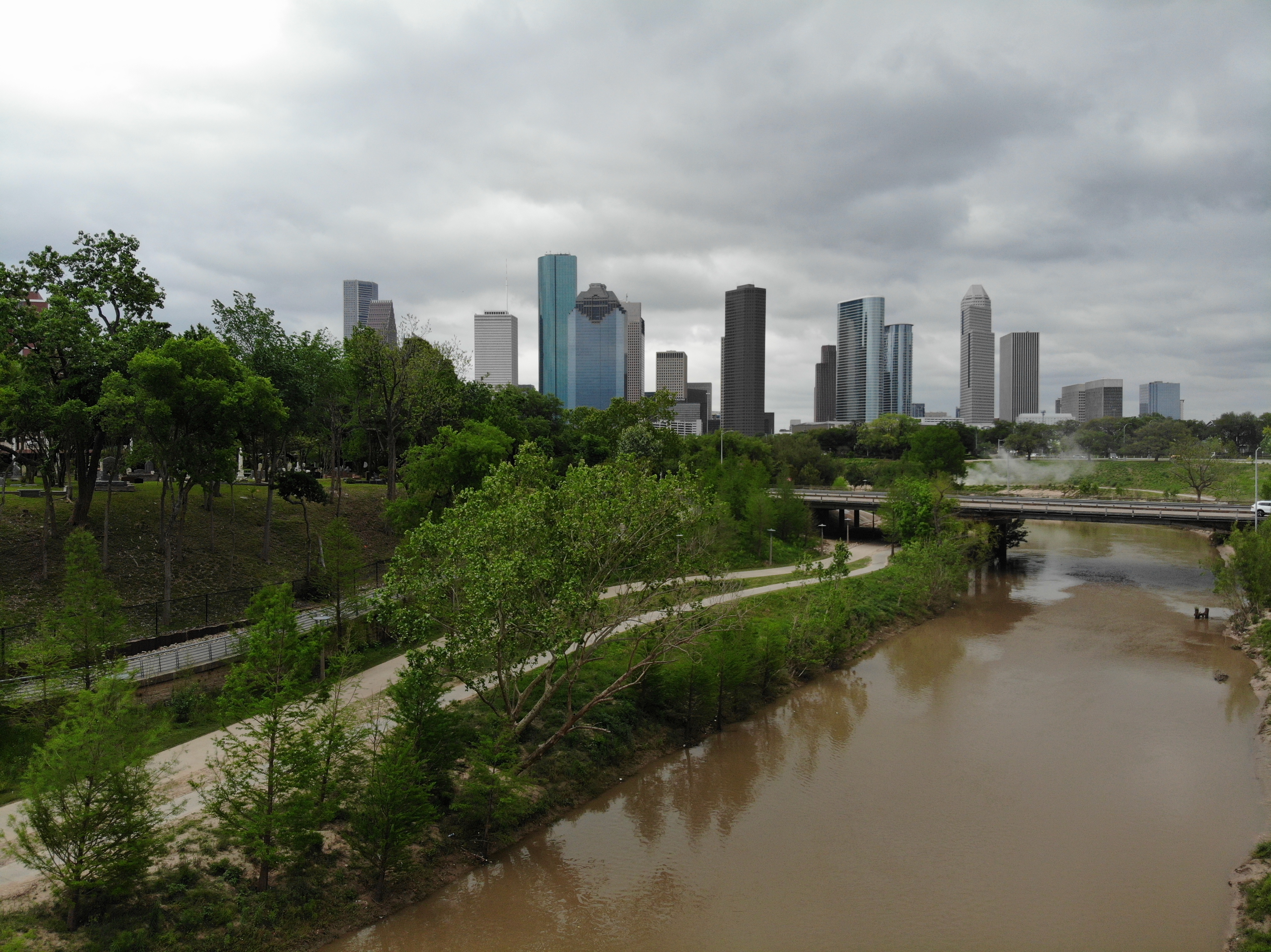 Downtown Houston skyline above Buffalo Bayou Park on a cloudy day
