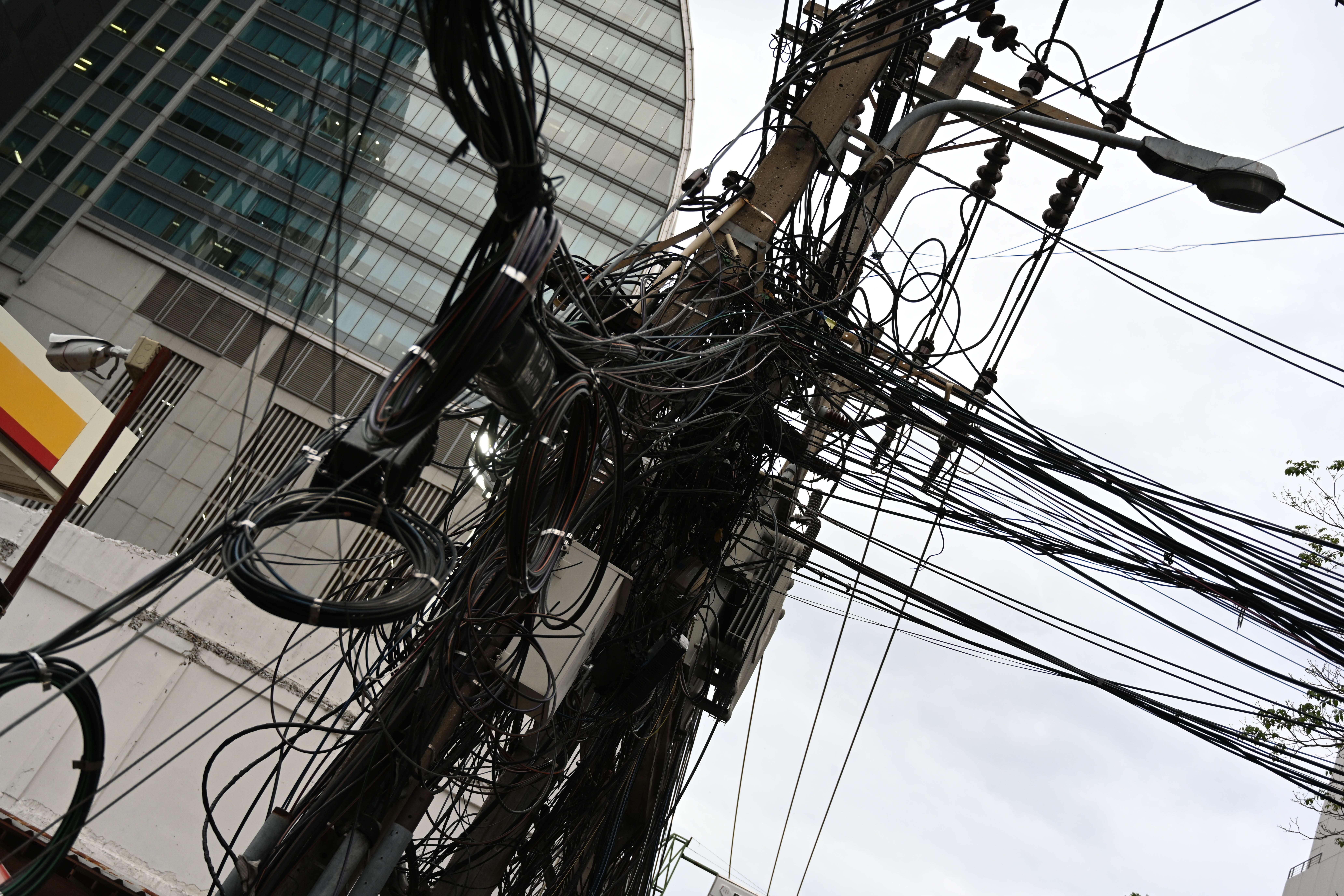 Dense overhead street wiring near Khao San Road in Bangkok