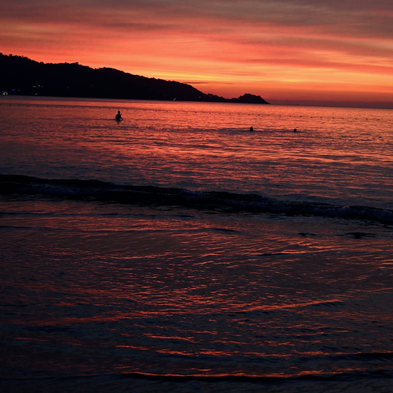 Orange sunset over the water from a Phuket beach