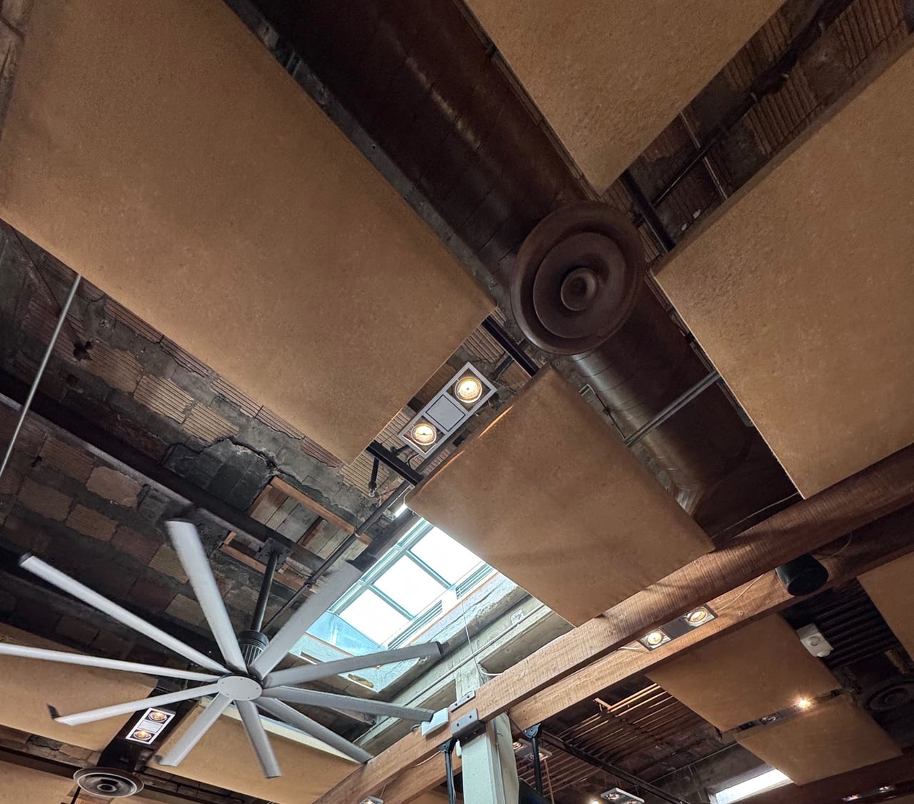 Exposed bow trusses and patched ceiling at Ballast Point Little Italy