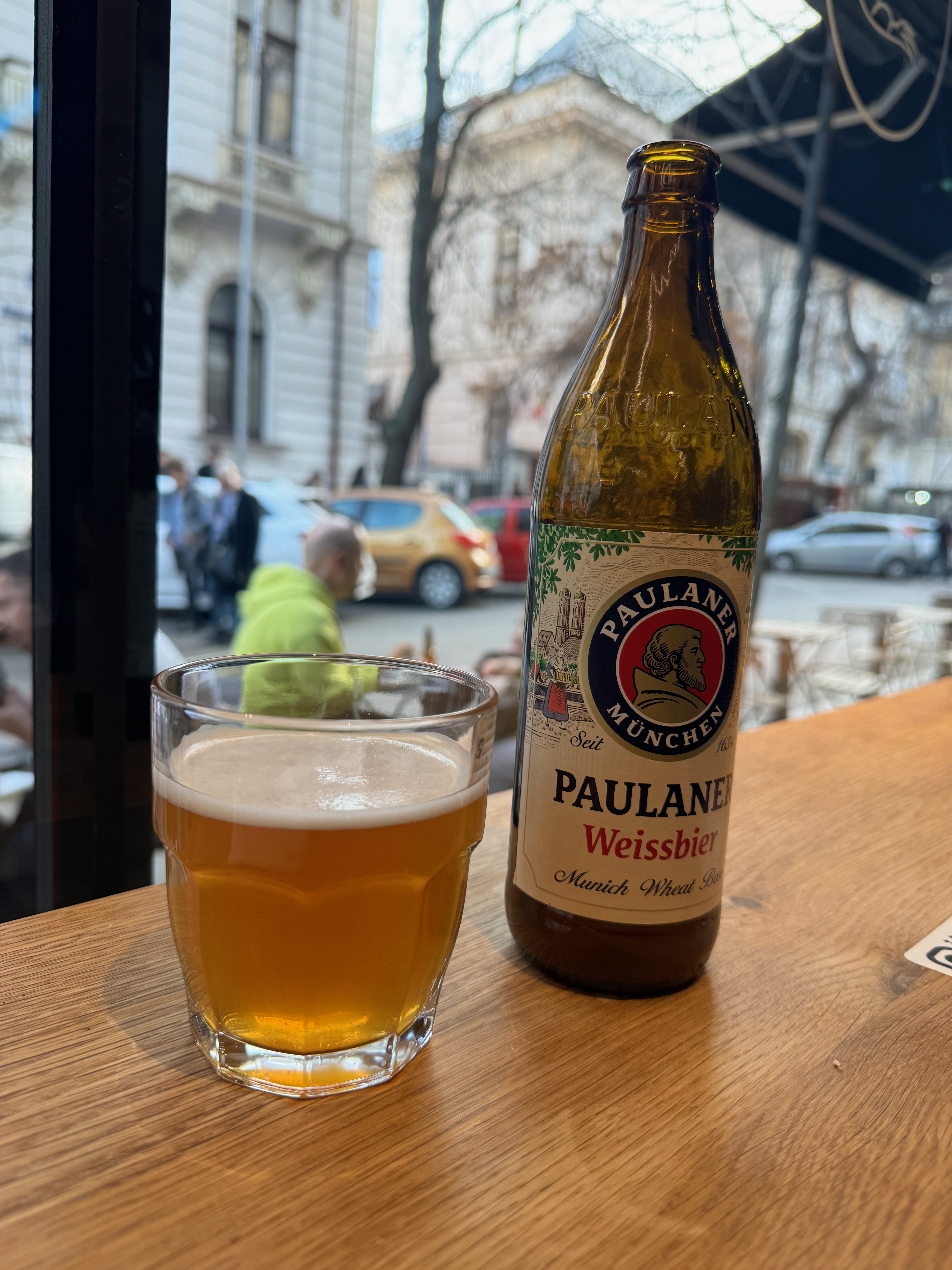 A beer on a table by the window at Meygu in Bucharest