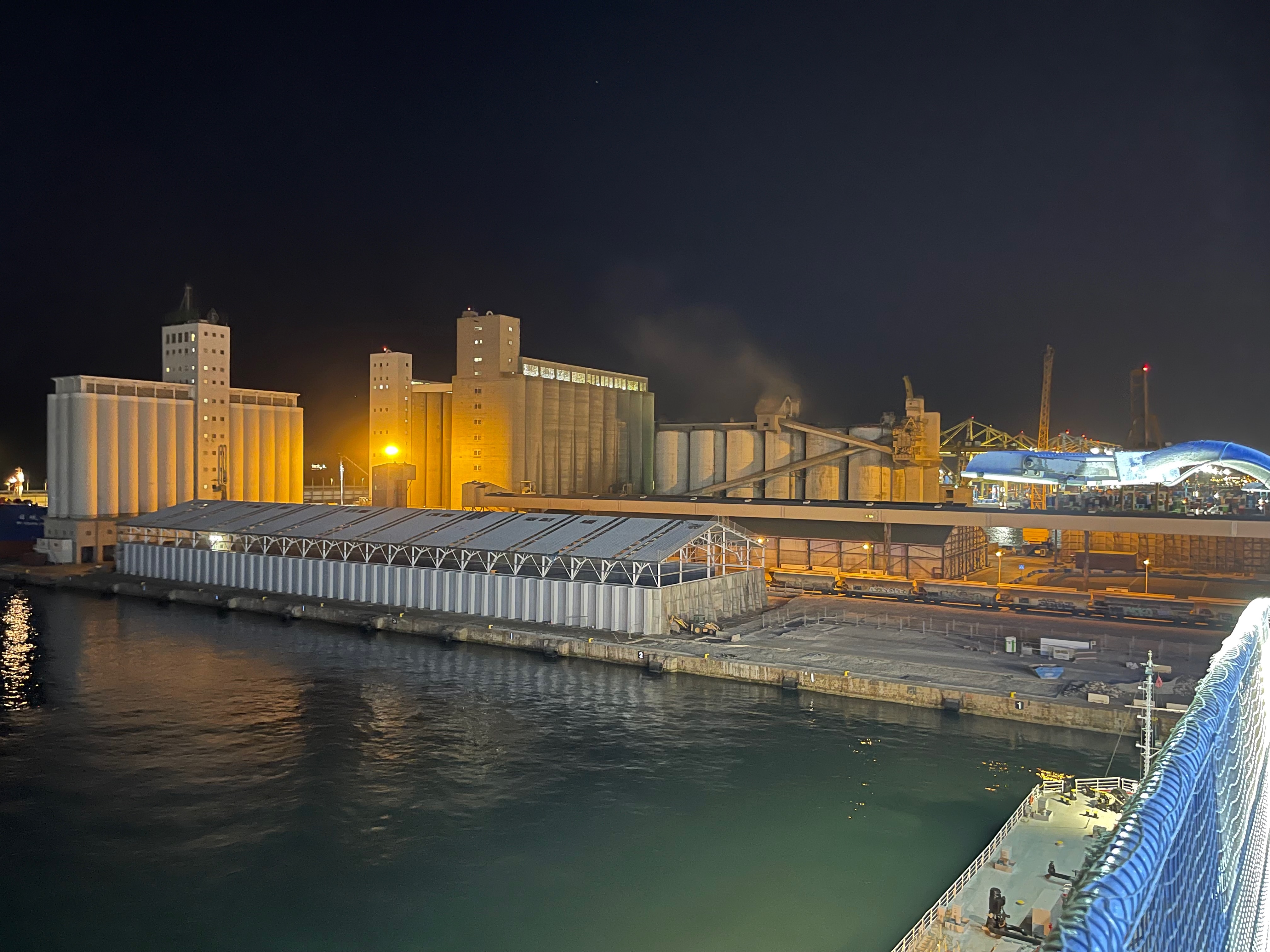 Civitavecchia ferry terminal buildings at night from the ship.