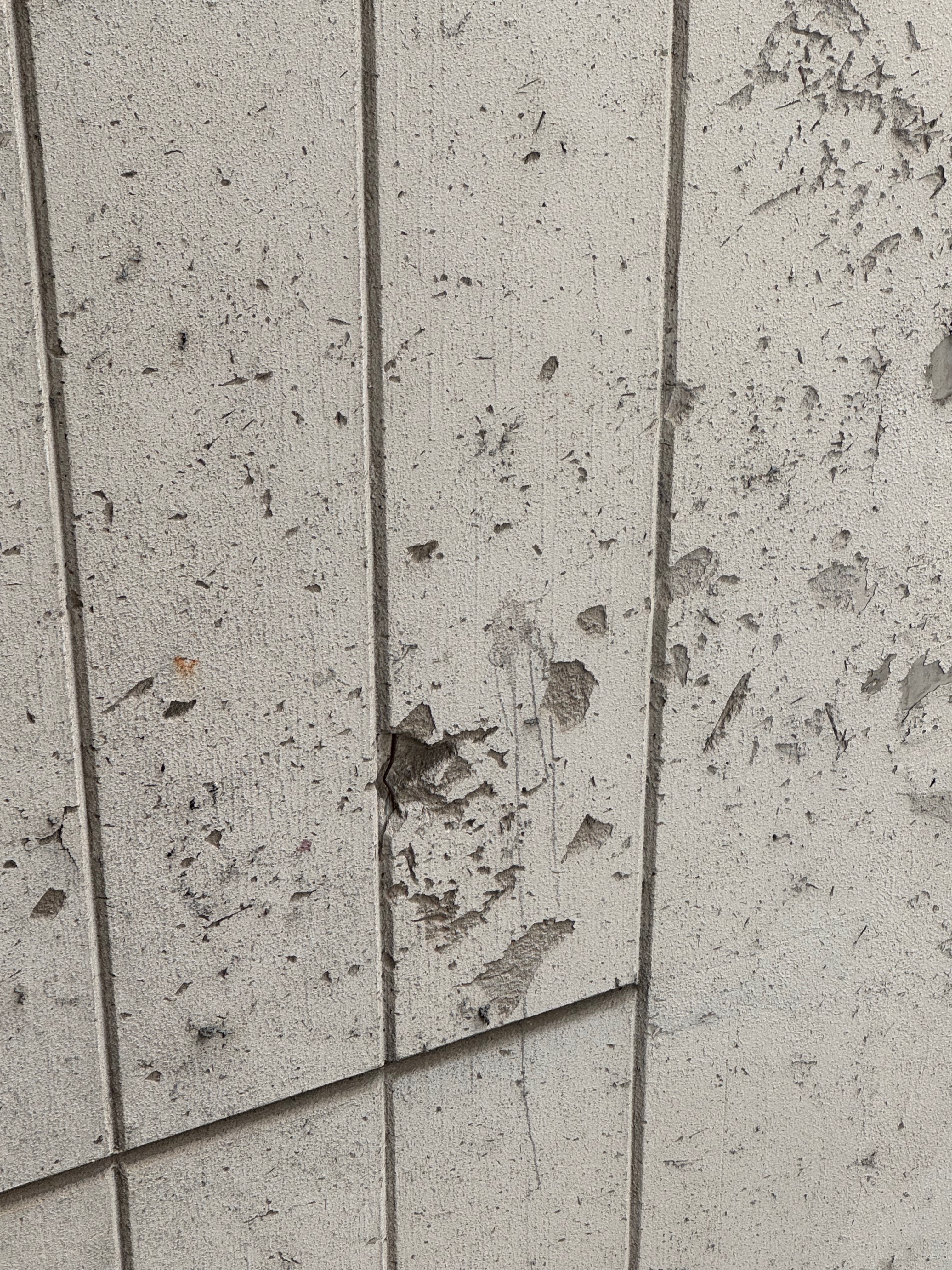 Shell-scarred wall detail in Sarajevo