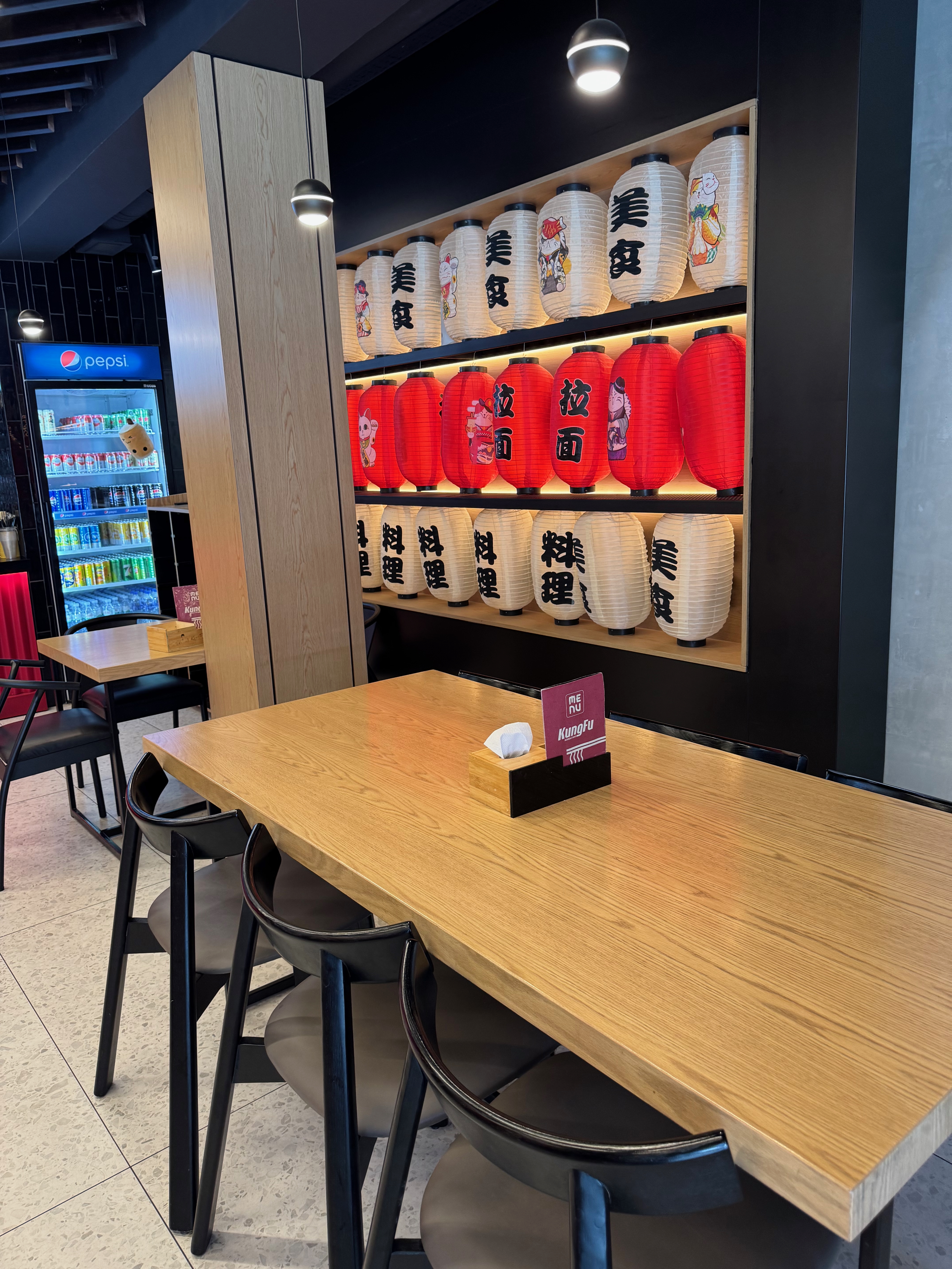 Lanterns and tables inside Kungfu Noodle Bar in Tirana