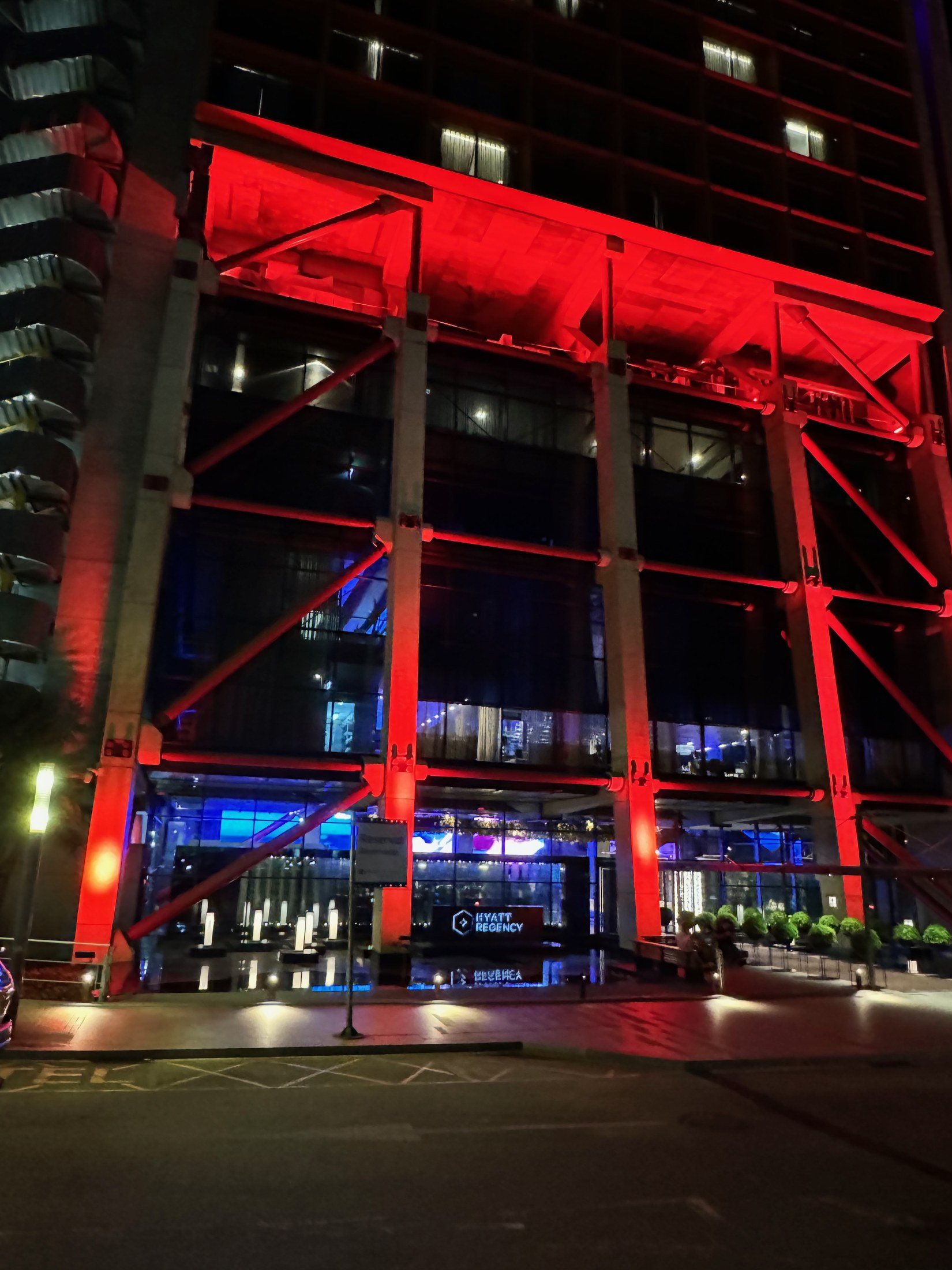 Hyatt Regency Barcelona Tower lit red at night in L'Hospitalet