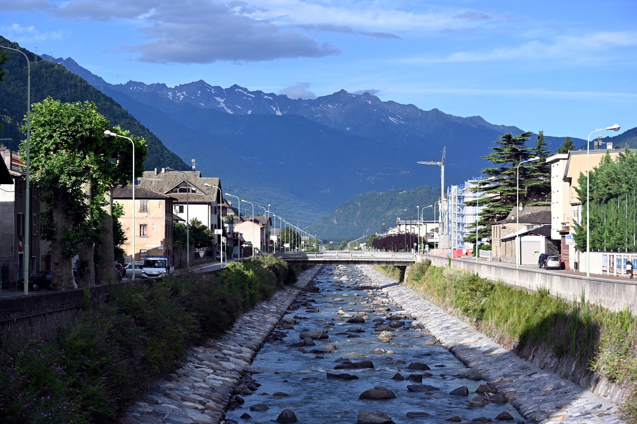 The river through Tirano with Alpine mountains beyond town